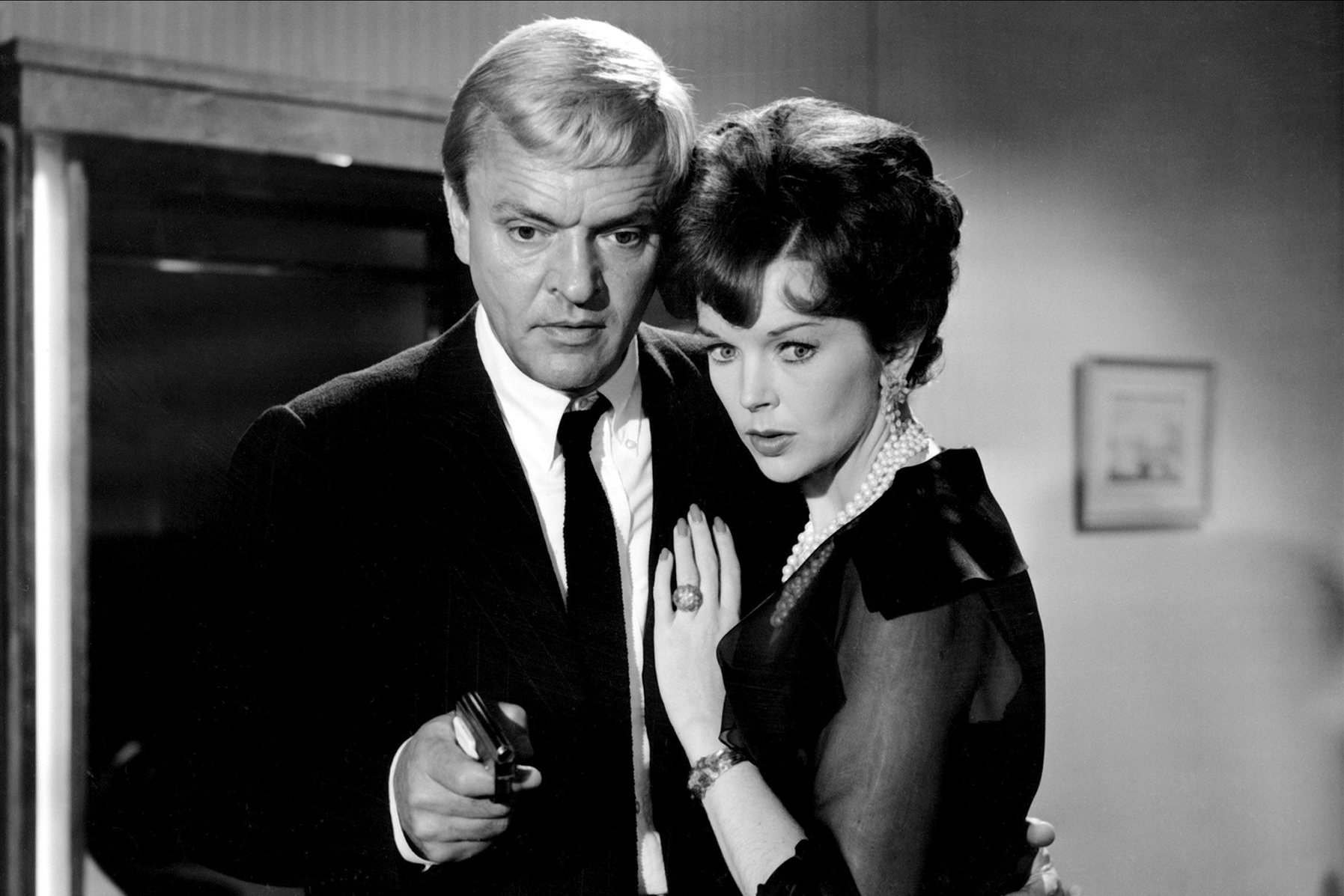 American businessman Peter van Eyck) with Dawn Addams as he investigates the mysteries of the Luxor Hotel in The 1000 Eyes of Dr. Mabuse (1960)