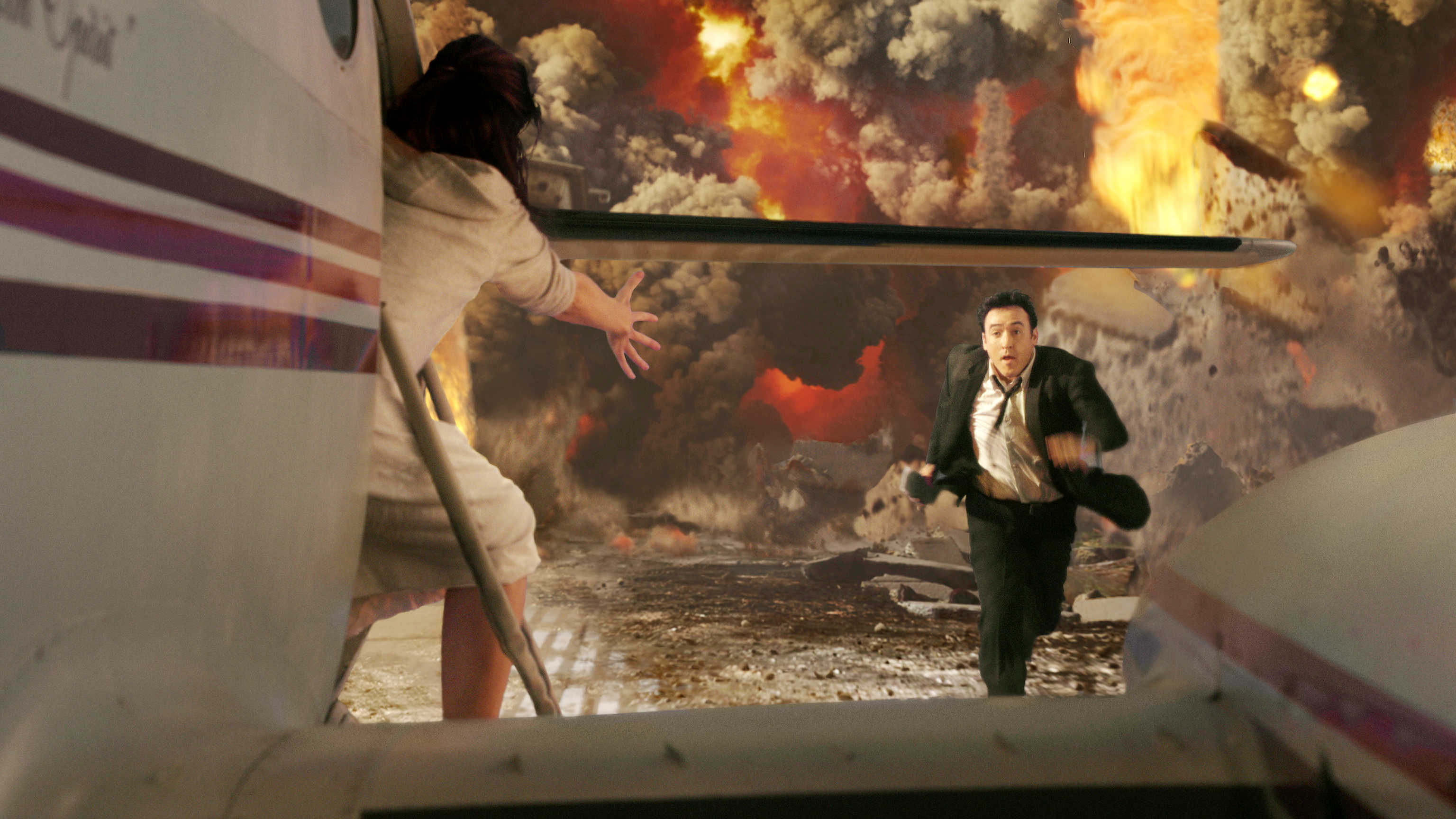 John Cusack races to get to a departing plane as Yellowstone erupts in 2012 (2009)