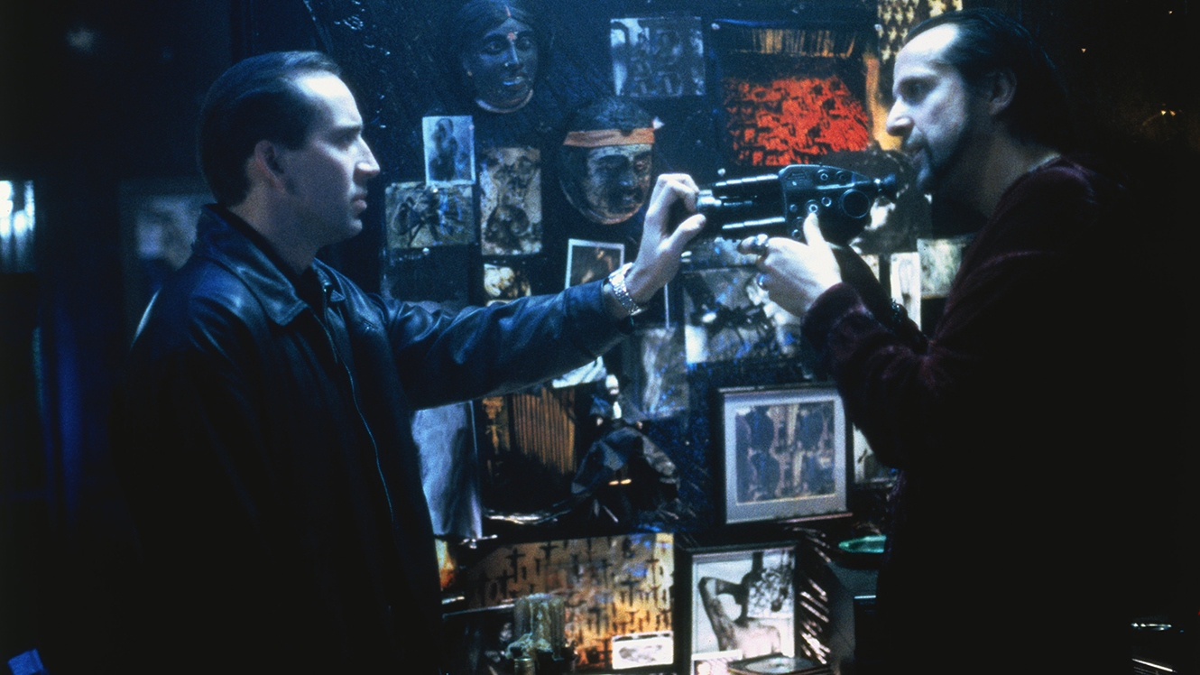 (l to r) Private detective Nicolas Cage confronts snuff movie maker Peter Stormare in 8MM (1999)