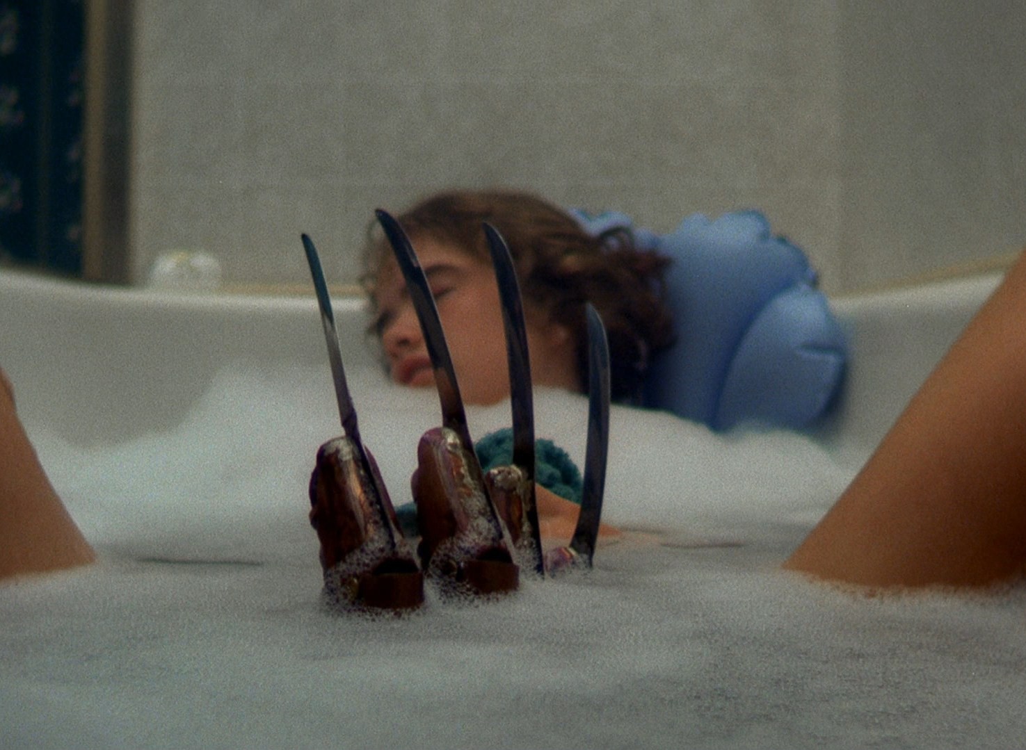 Freddy's claws emerge as Heather Langenkamp drifts off in the bath in A Nightmare on Elm Street (1984)