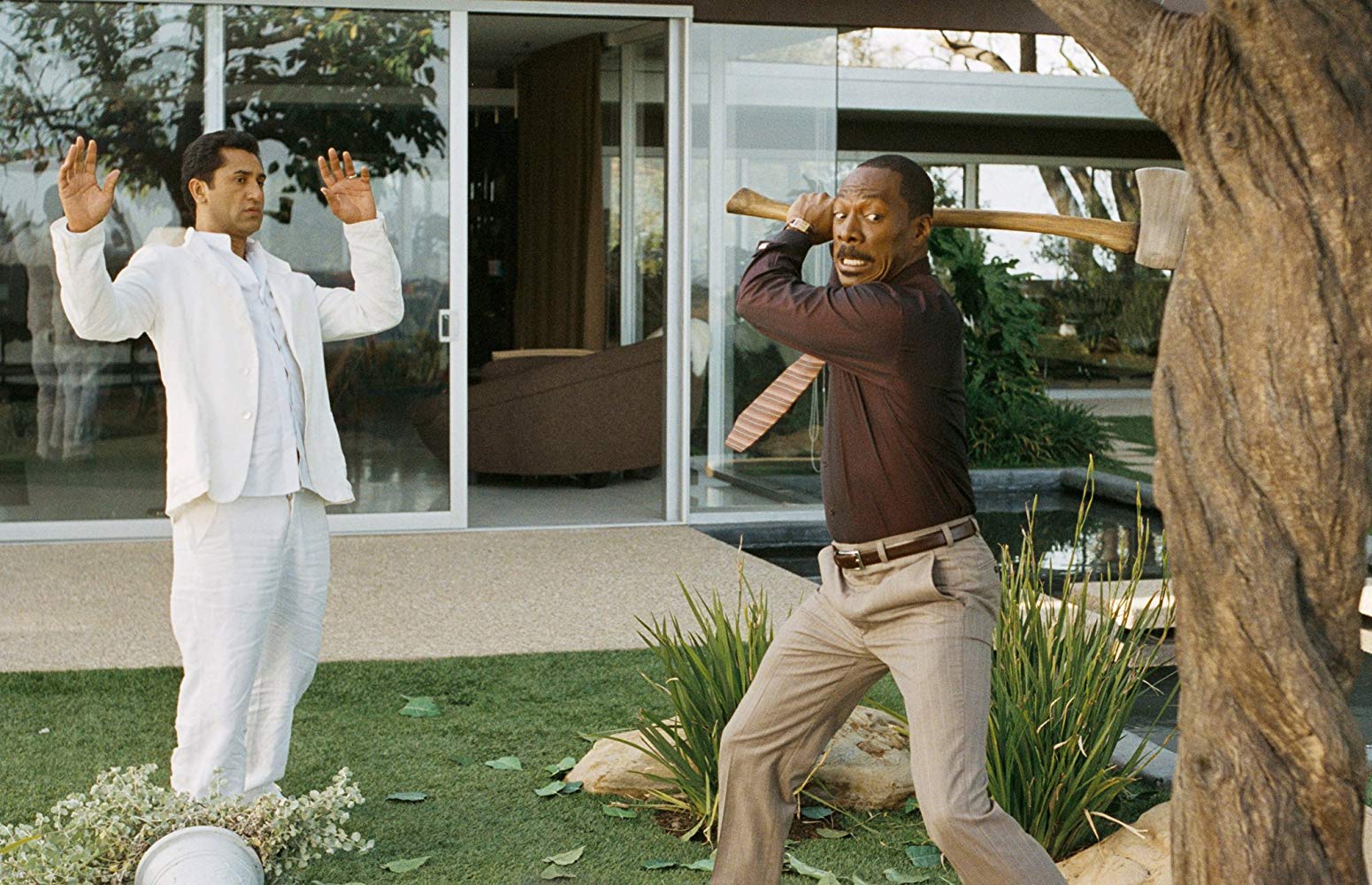 Guru Cliff Curtis looks on as Eddie Murphy goes to attack the tree with an axe in A Thousand Words (2012)