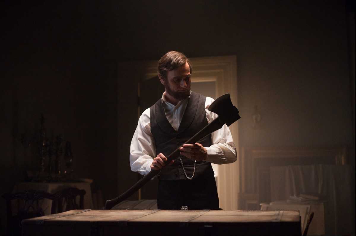 Abraham Lincoln (Benjamin Walker) prepares his axe for some vampire hunting in Abraham Lincoln, Vampire Hunter (2012)