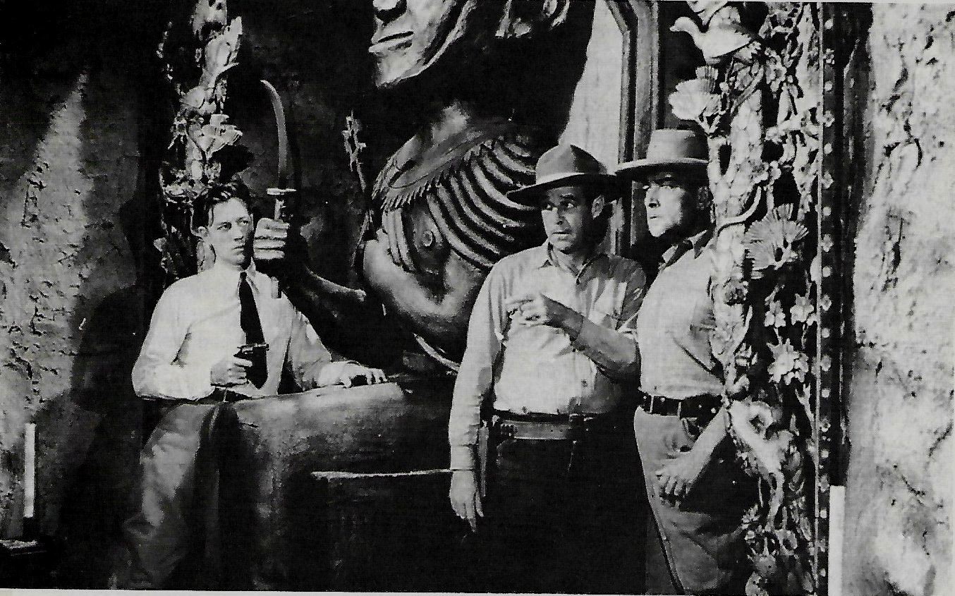 Flyer hero Ace Drummond (John ‘Dusty’ King) (l) waits to ambush two villains as they enter a temple in Ace Drummond (1936)