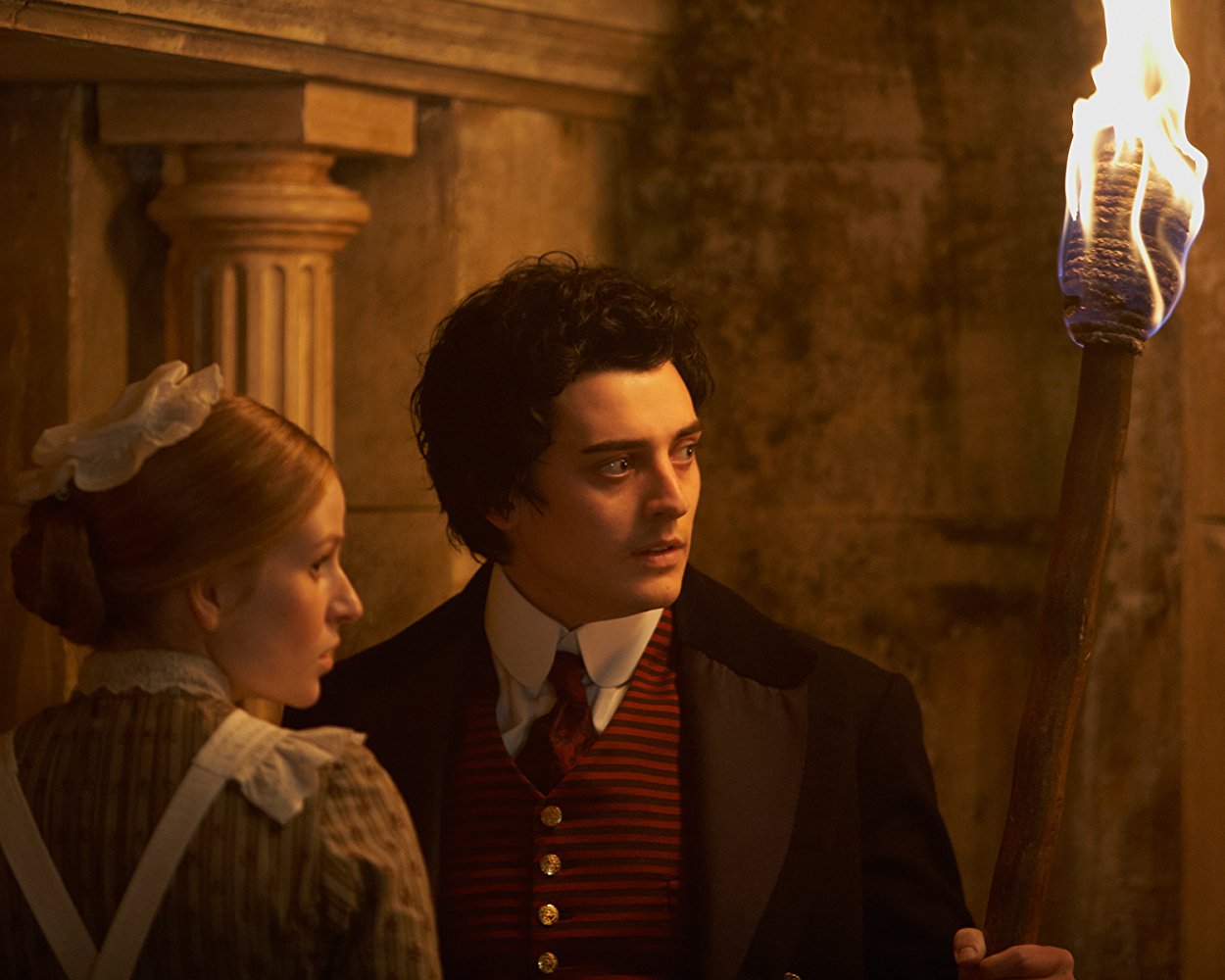 Mariah Mundi (Aneurin Barnard), along with the maid Sacha (Mella Carron), searches the secrets beneath the hotel in The Adventurer: The Curse of the Midas Box (2014)