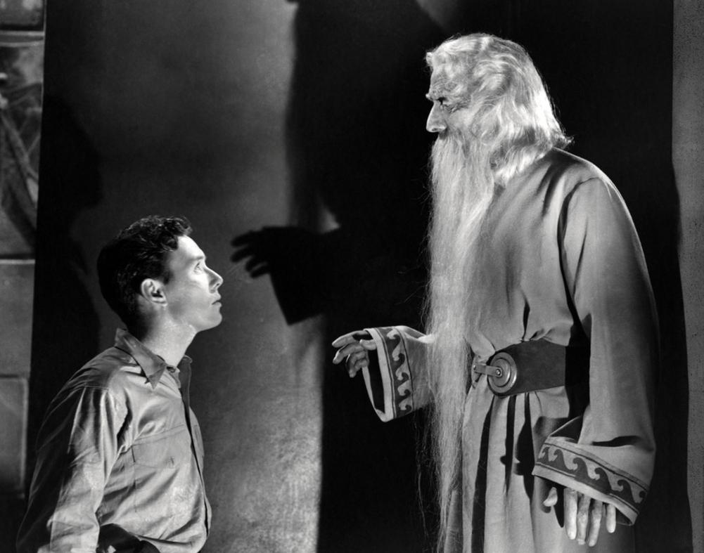 Billy Batson (Frank Coghlan Jr) is granted his powers by an ancient figure (Nigel De Brulier) in Adventures of Captain Marvel (1941)