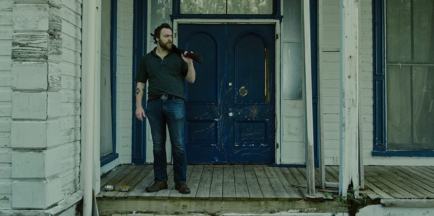 Hank (director/writer Jeremy Gardner) awaits the monster in After Midnight (2019)