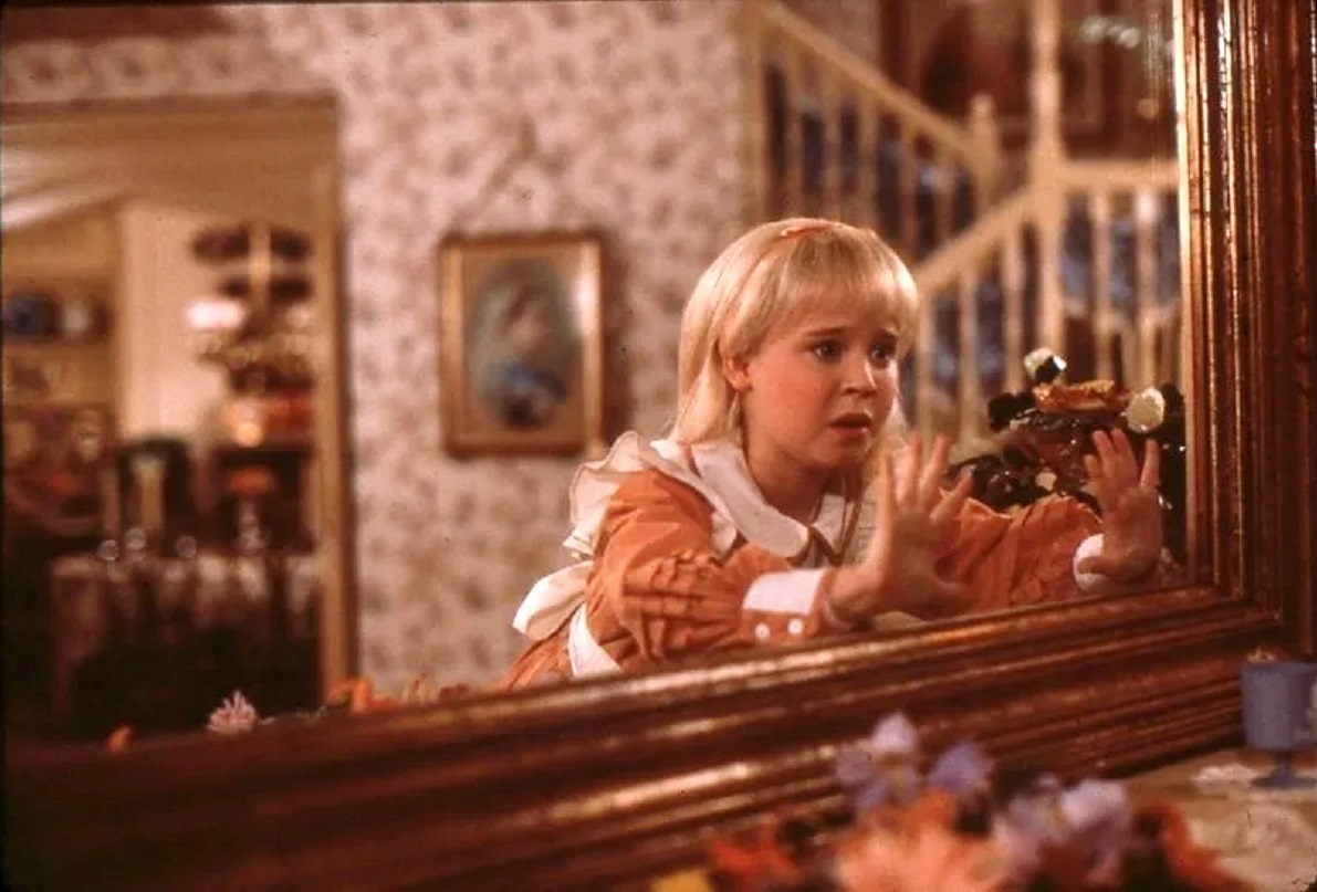 Alice (Natalie Gregory) and the looking glass in Alice in Wonderland (1985)