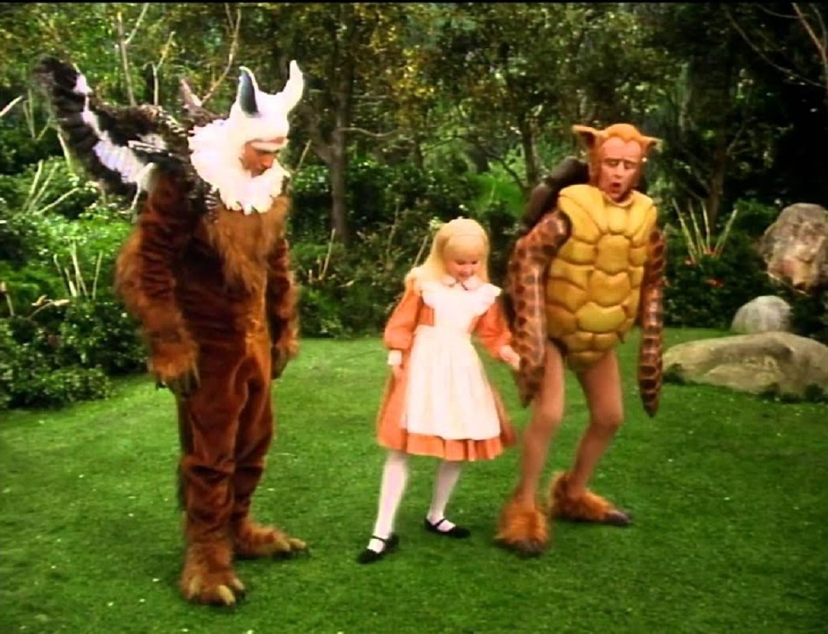 Alice (Natalie Gregory) with the Gryphon (Sid Caesar) and the Mock Turtle (Ringo Starr) in Alice in Wonderland (1985)