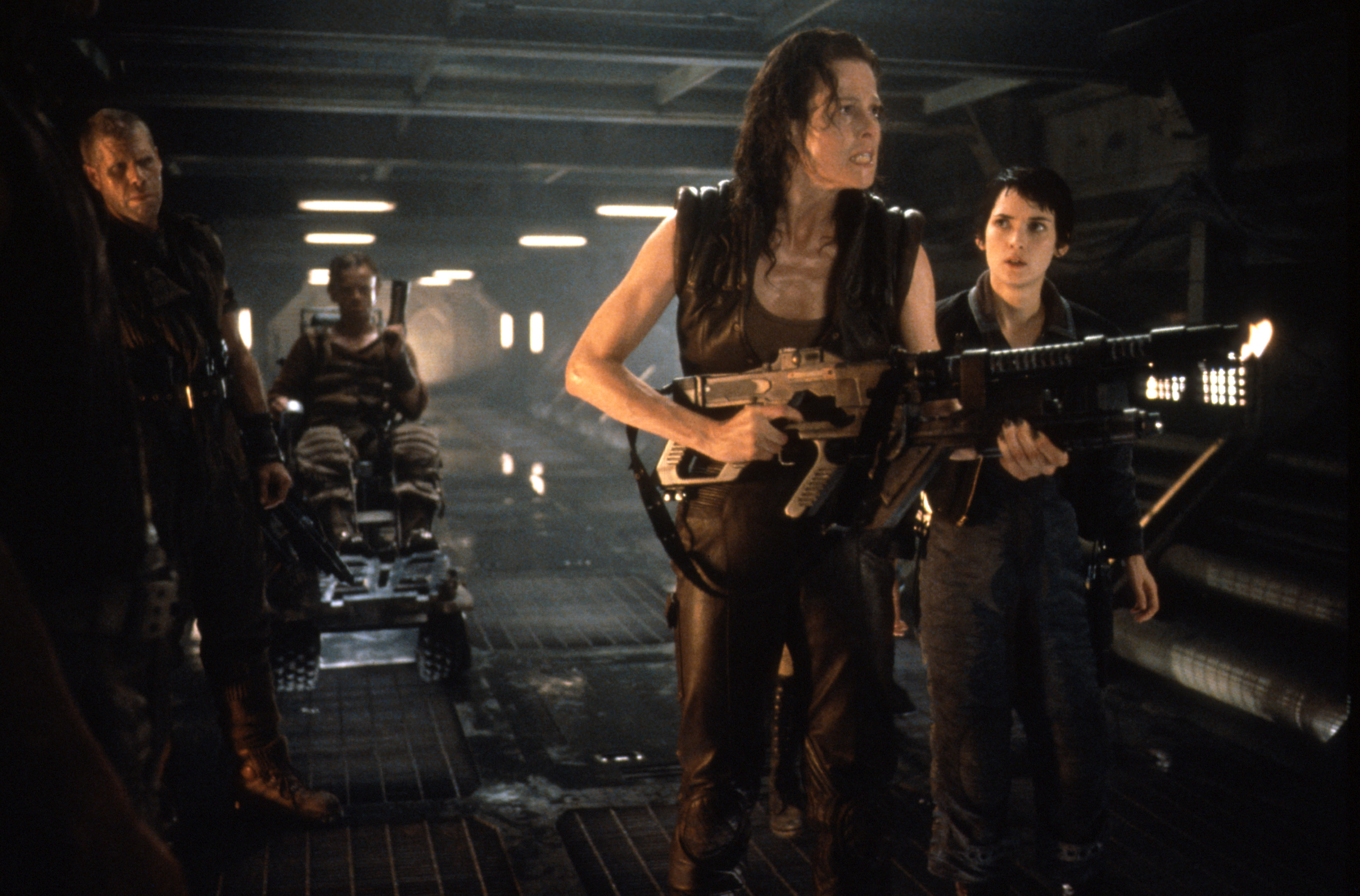 (l to r) Johner (Ron Perlman), Vreiss (Dominique Pinon), Ripley (Sigourney Weaver) and Annalee (Winona Ryder) make their way through the ship in Alien: Resurrection (1997)