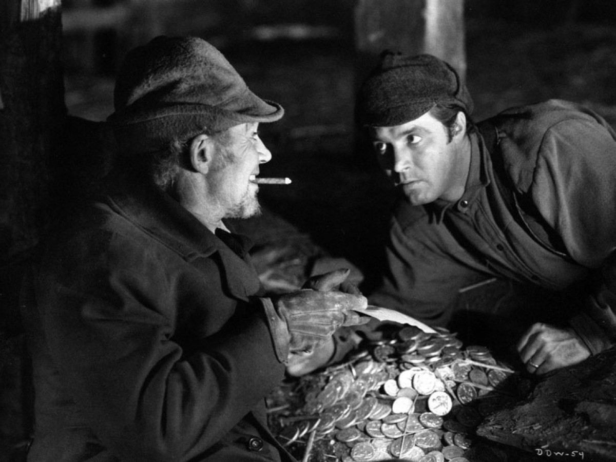 (l to r) Mr Scratch (Walter Huston) tempts Jabez Stone (James Craig) in All That Money Can Buy (1941)