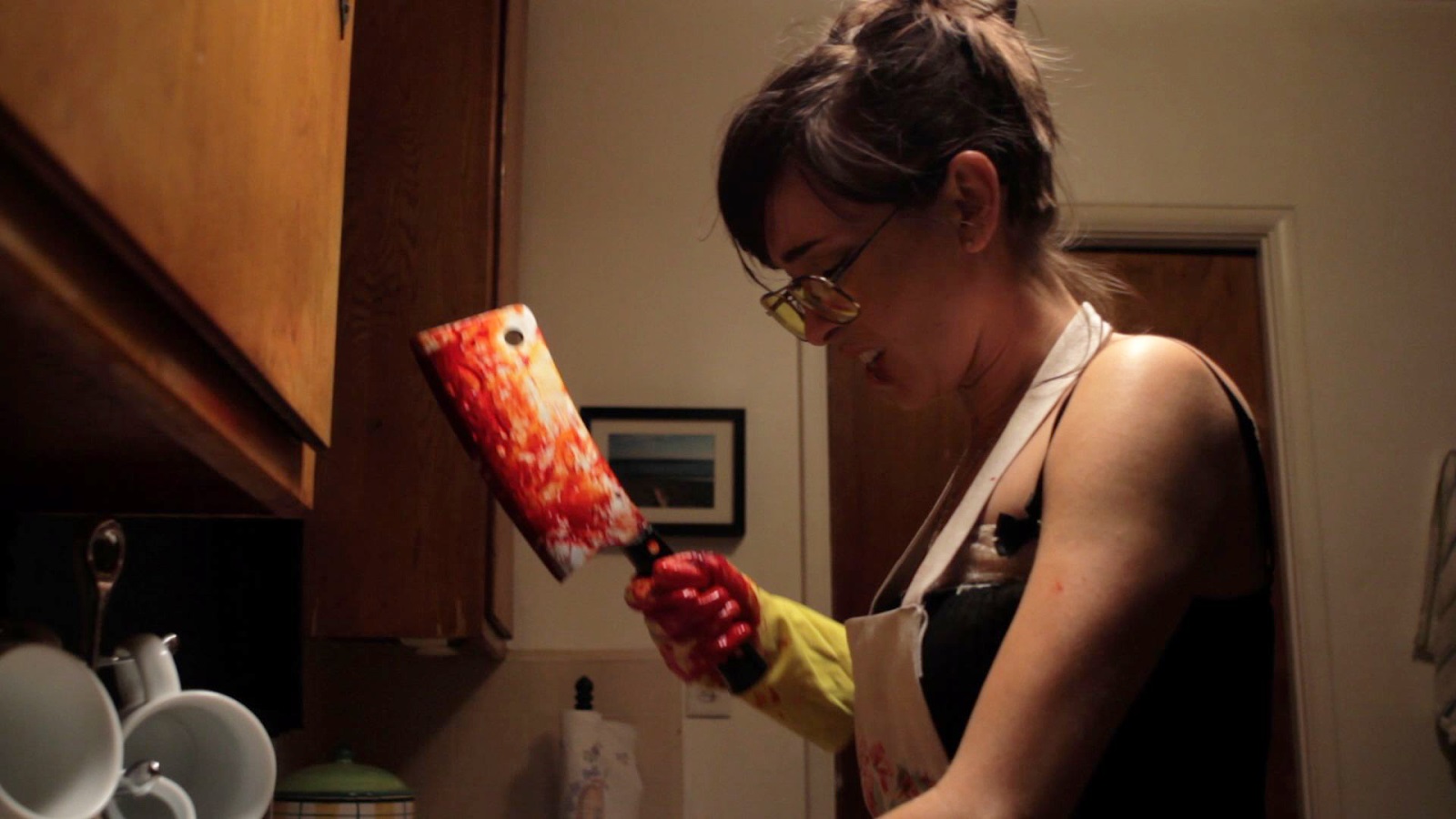 Not the Alice in Wonderland you knew as a child - Alyce (Jade Dornfeld) carves up a body with a meat cleaver in Alyce (2011)