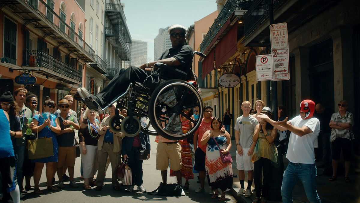 Stephen Dorff (r in red mask) levitates wheelchair-ridden best friend Eddie Griffin) in American Hero (2015)