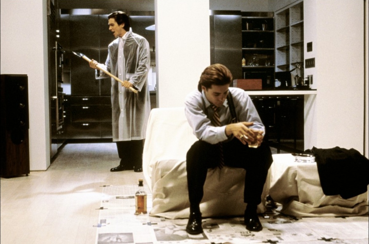 (l to r) Christian Bale prepares to dispatch Jared Leto with an axe in American Psycho (2000)