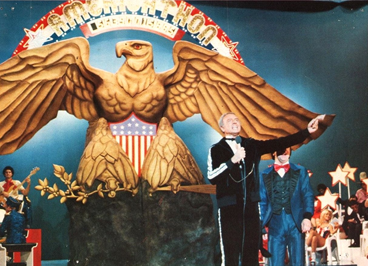 Monty Rushmore (Harvey Korman), host of the telethon to save America from bankruptcy in Americathon (1979)