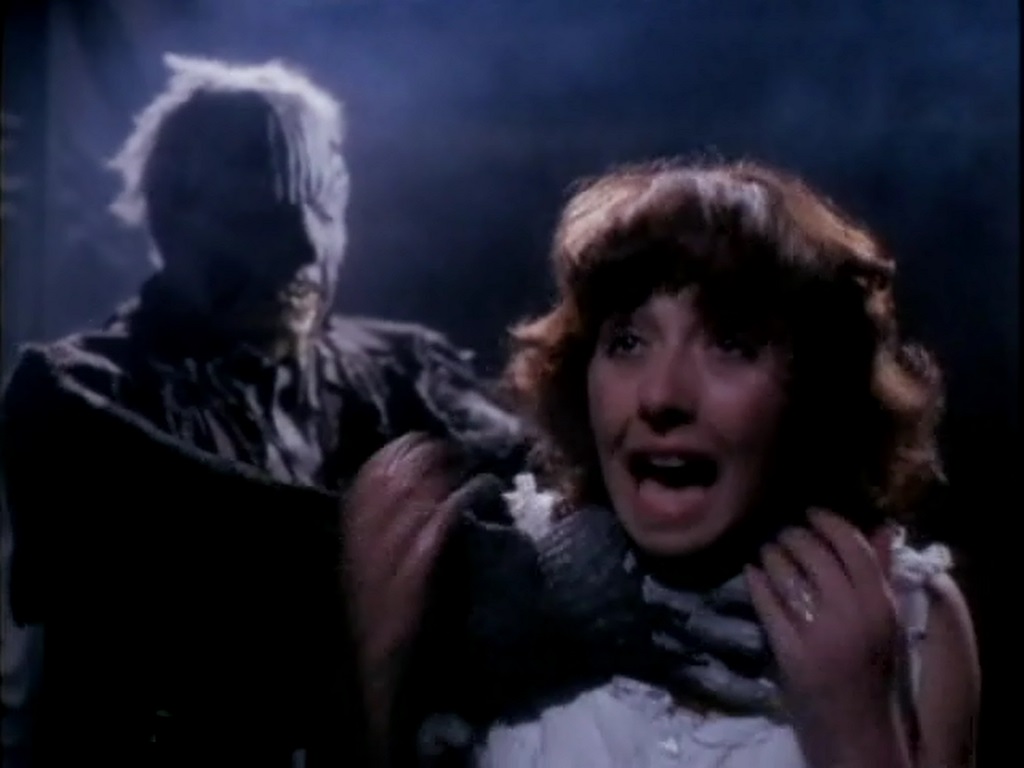 Dawna Wightman menaced by the figure lurking in the house in The Amityville Curse (1989)