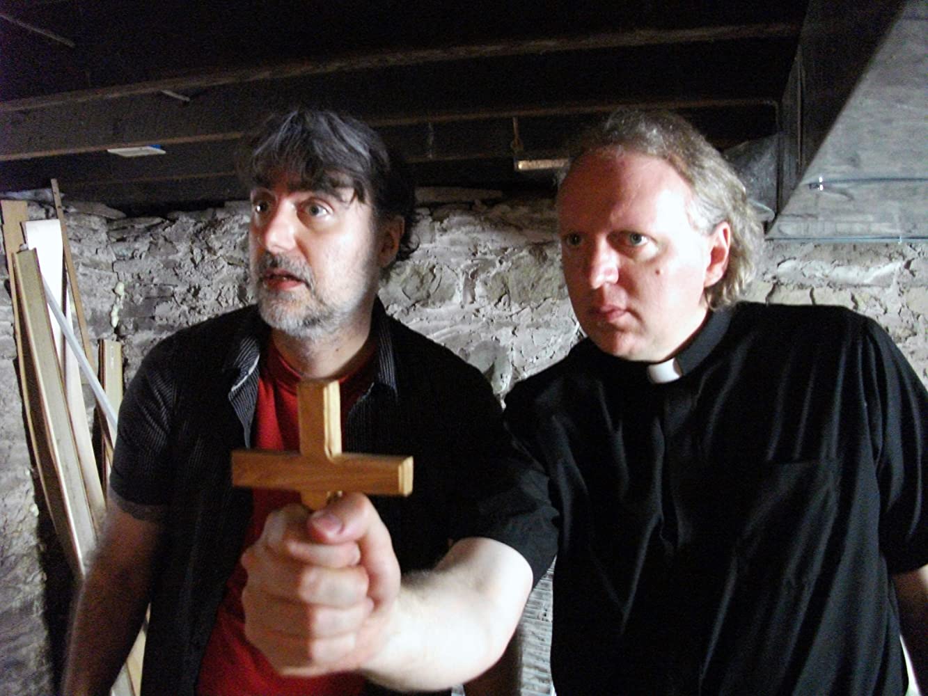 (l to r) James Carolus and priest Jeff Kirkendall perform an exorcism in Amityville Exorcism (2017)