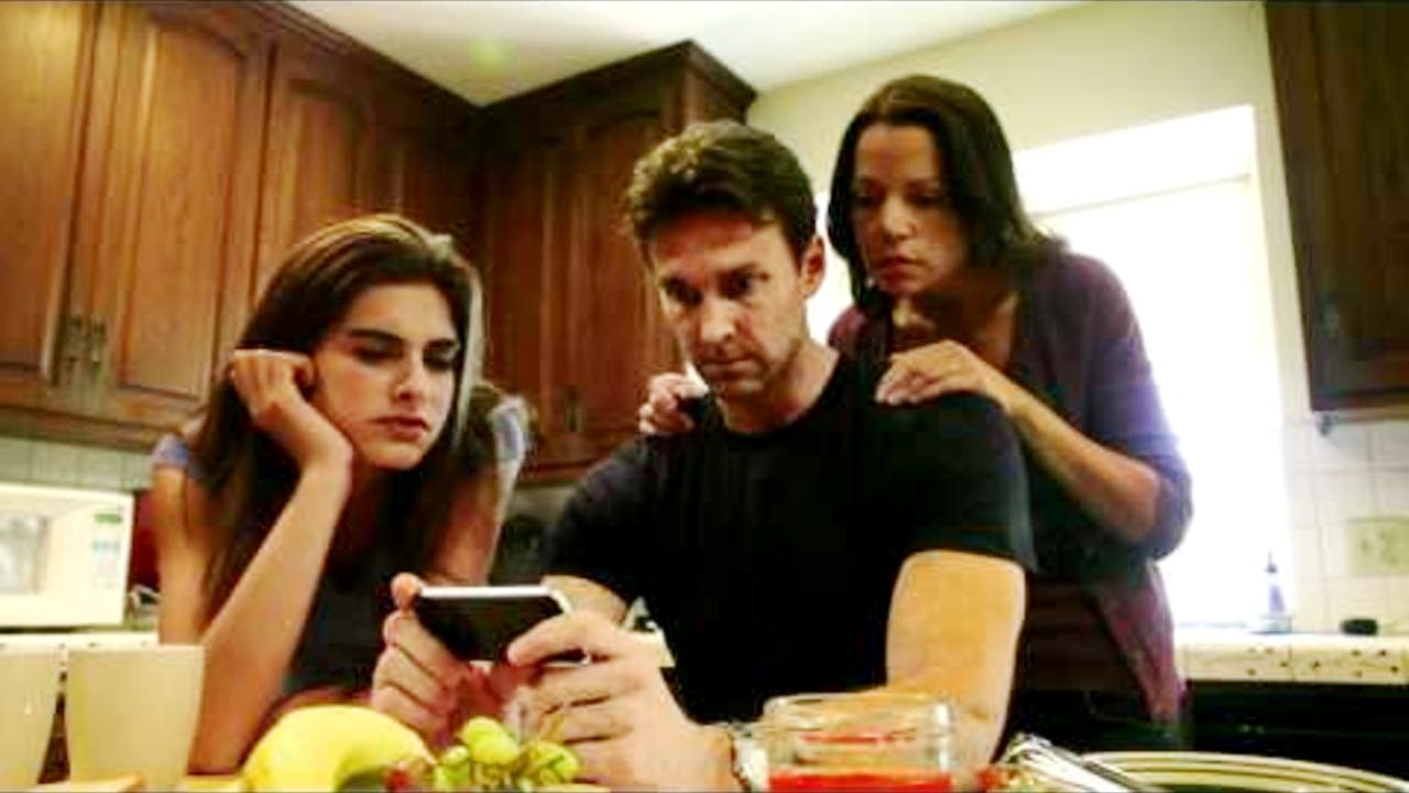 Nadine Crocer, Jason Williams and Amy Van Horne review the video footage in The Amityville Haunting (2011)1