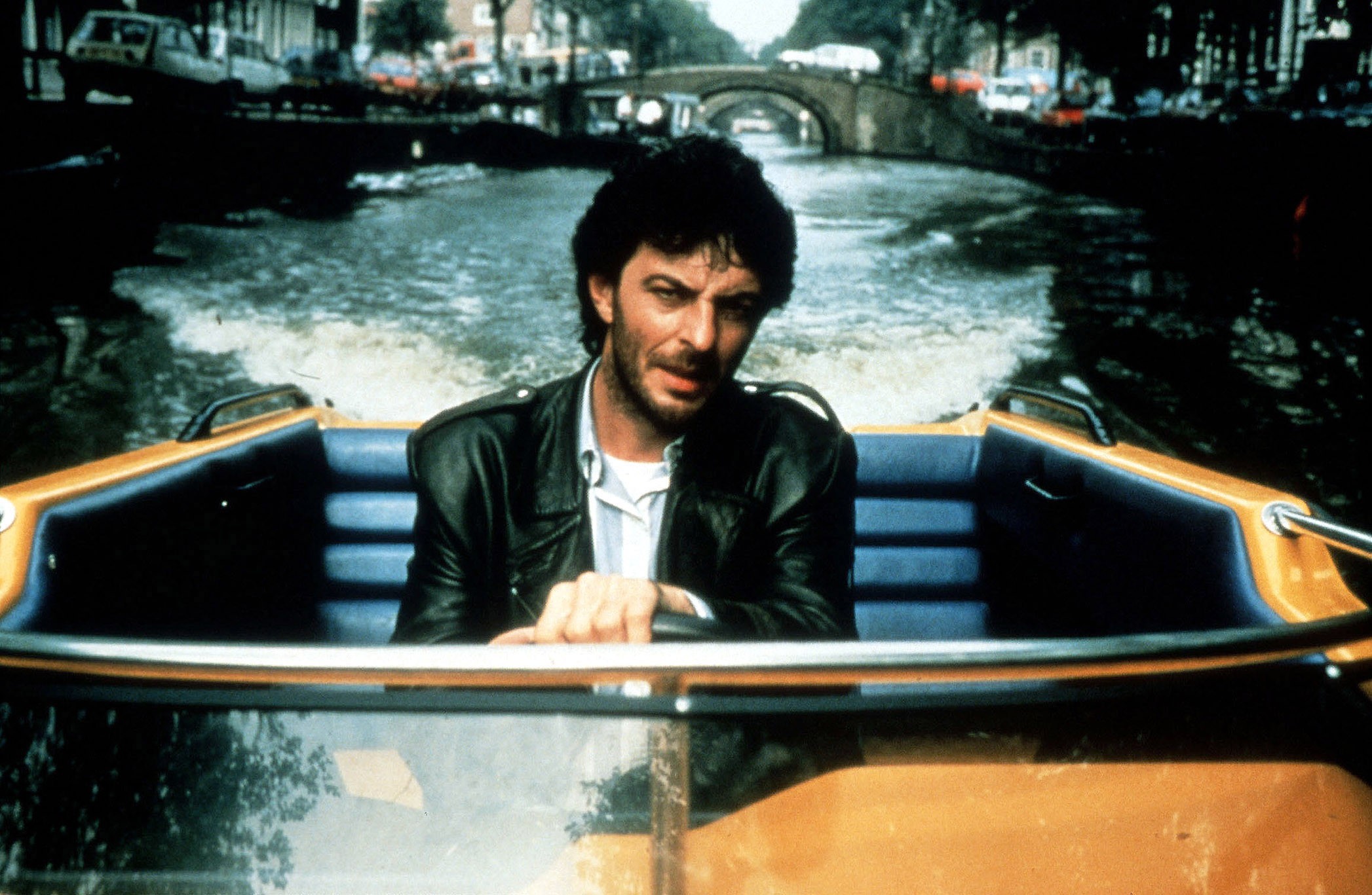 Detective hero Huub Stapel in the film's standout speedboat chase sequence in Amsterdamned (1988)