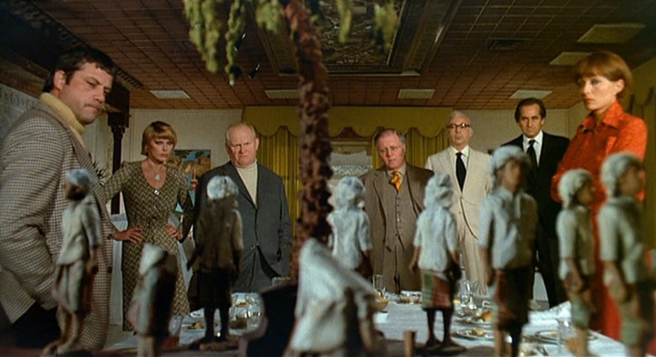 The gathered guests - (l to r) Oliver Reed, Elke Sommer, Gert Frobe, Richard Attenborough, Herbert Lom, Alberto de Mendoza, Stephane Audran in And Then There Were None (1974)