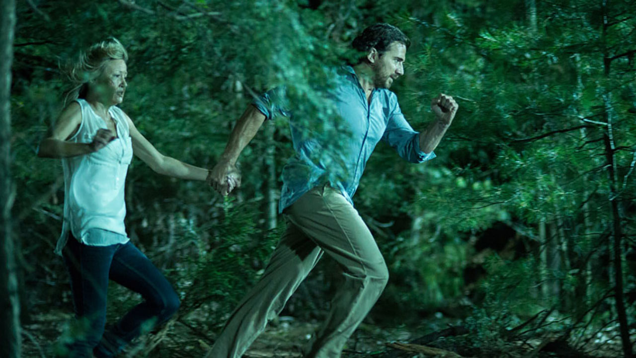 Joey Lauren Adams and Thorsten Kaye flee from the creature in Animal (2014)