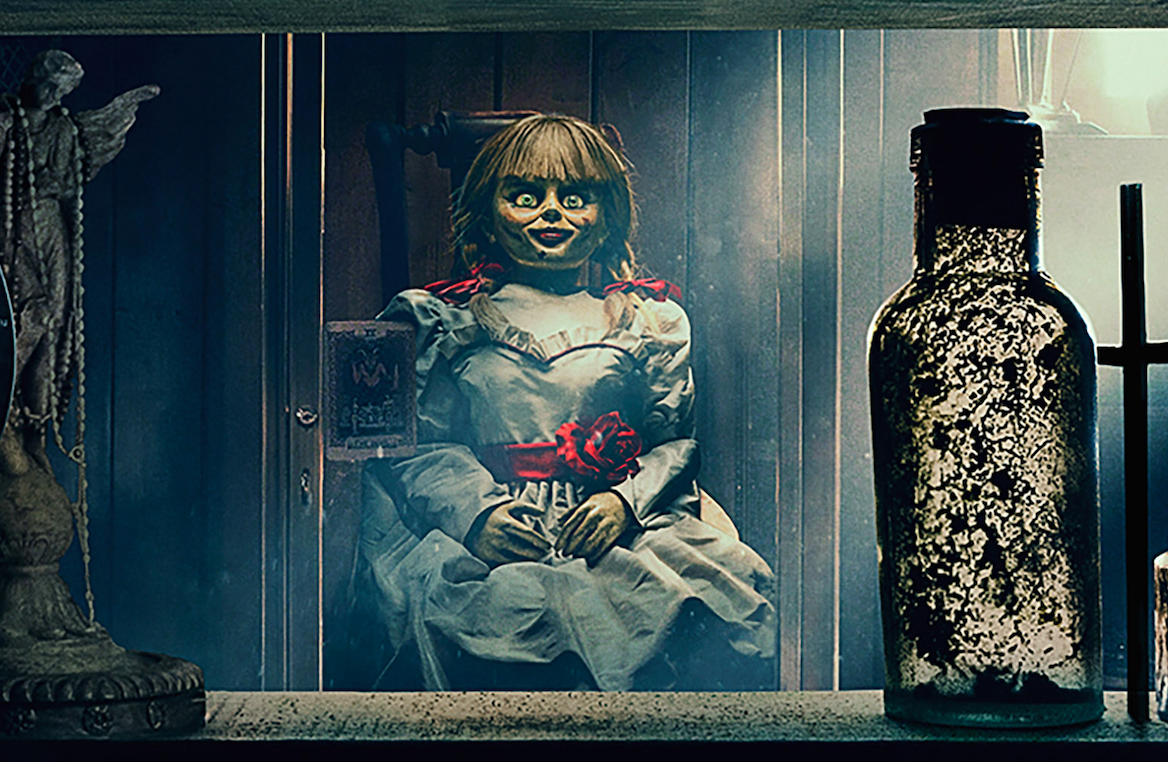 The Annabelle doll in her cabinet in the Warren's museum in Annabelle Comes Home (2019)