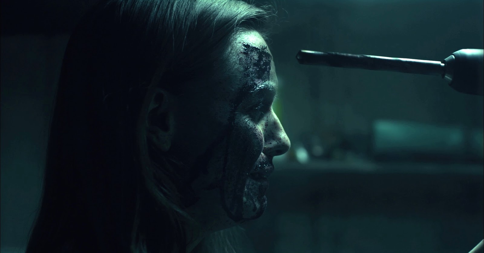 Michelle Mylett about to have her forehead trepanned with a power drill in Antisocial (2013)