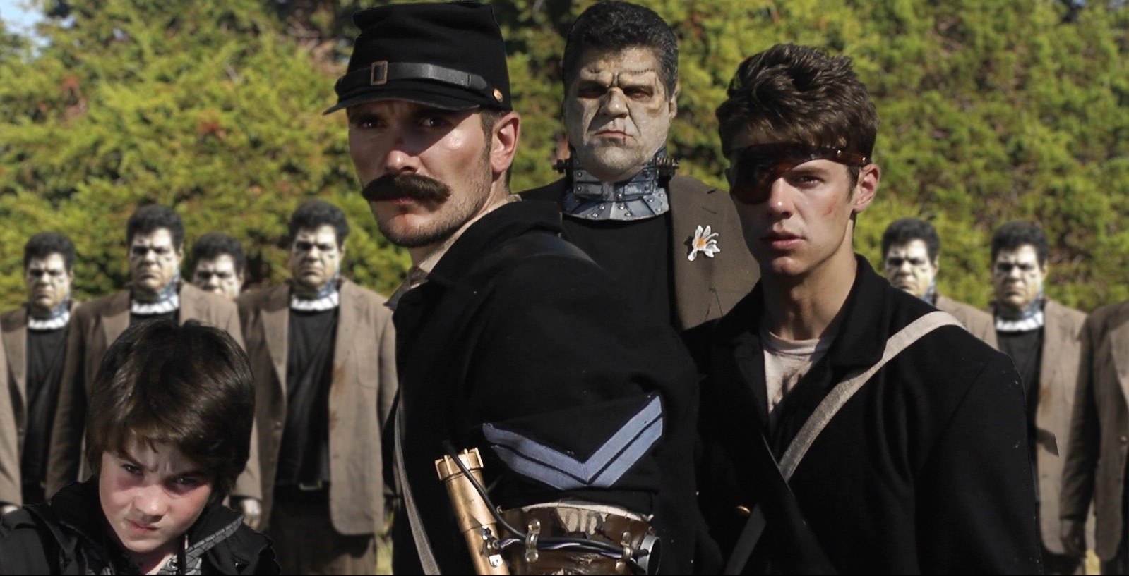 (l to r) Igor (Christian Bellgardt), Corporal Solomon Jones (Rett Terrell), the Frankenstein Monster (Eric Gesecus) and time traveler Alan Jones (Jordan Farris) in Army of Frankensteins (2014)