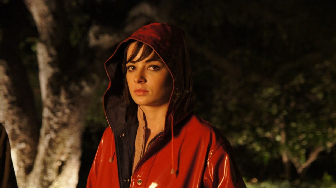 The red-raincoated Hannah (Ashley Rickards) in At the Devil's Door (2014)