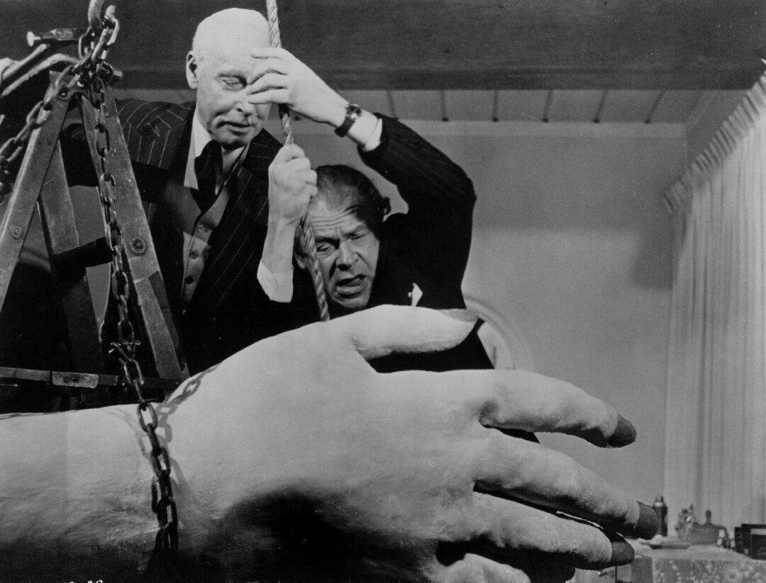 The authorities attempt to restrain the 50 Foot Woman's papier-mache hand in Attack of the 50 Foot Woman (1958)