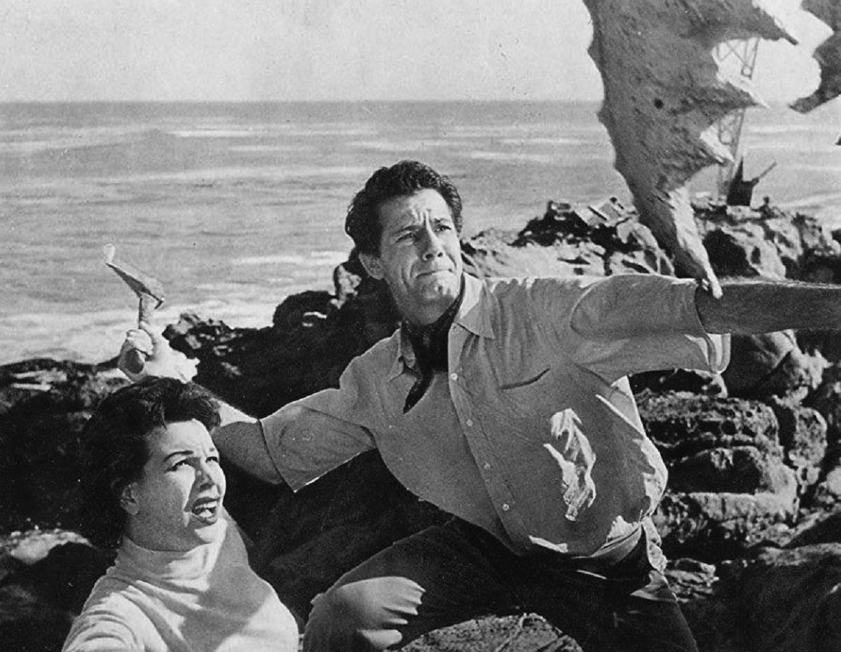 Pamela Duncan and Richard Garland fend off attack by a giant crab claw in Attack of the Crab Monsters (1957)