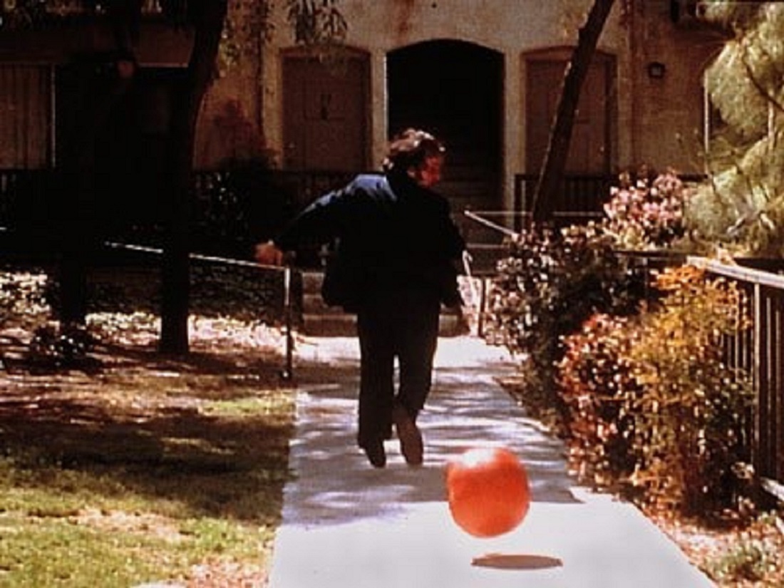 A killer tomato pursues a human victim in Attack of the Killer Tomatoes (1978)