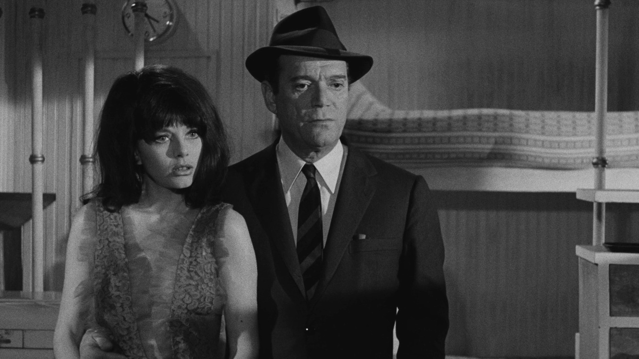 Interpol agent Al Pereira (Eddie Constantine) with Sophie Hardy in Attack of the Robots (1966)