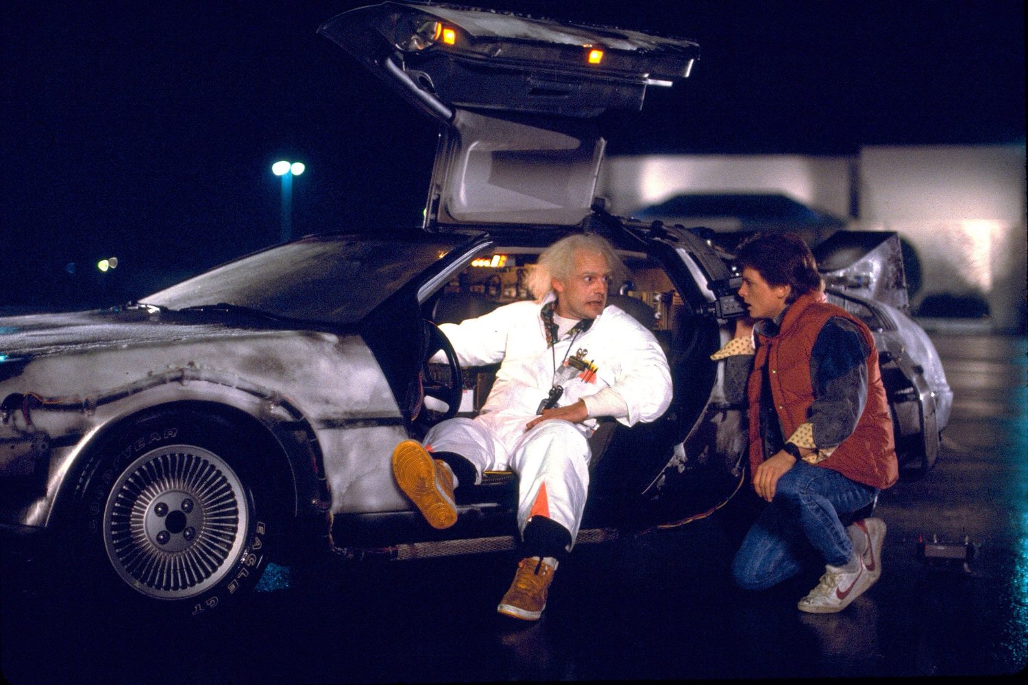 Doc Brown (Christopher Lloyd) and Marty McFly (Michael J. Fox) with the DeLorean in Back to the Future (1985)