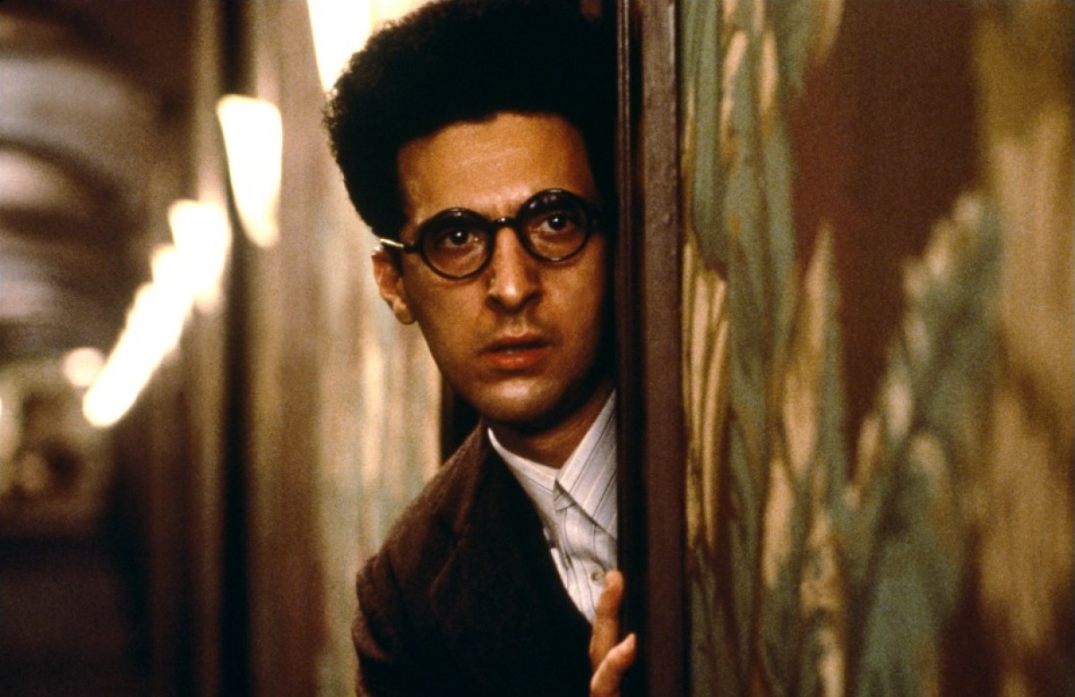 John Turturro as Barton Fink, a screenwriter with writer's block and crumbling mental state