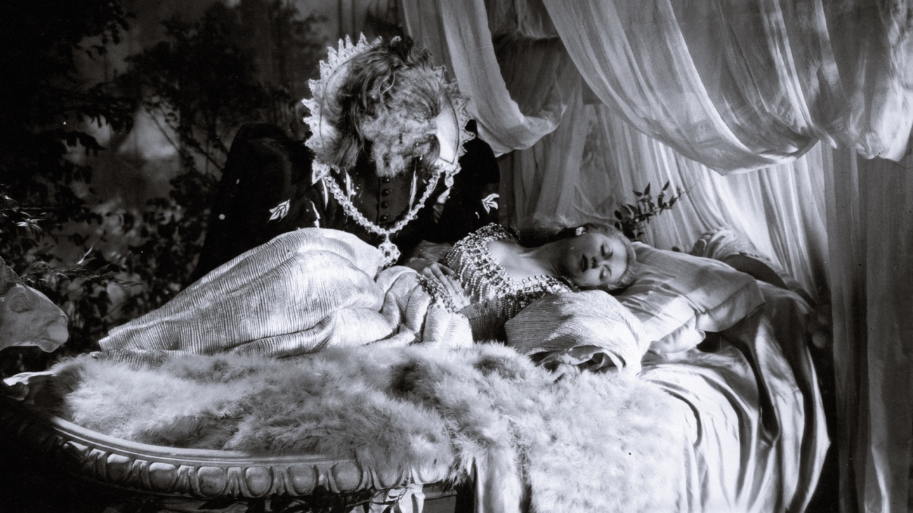 The Beast (Jean Marais) peeps in on a sleeping Beauty (Josette Day) in Beauty and the Beast (1946)