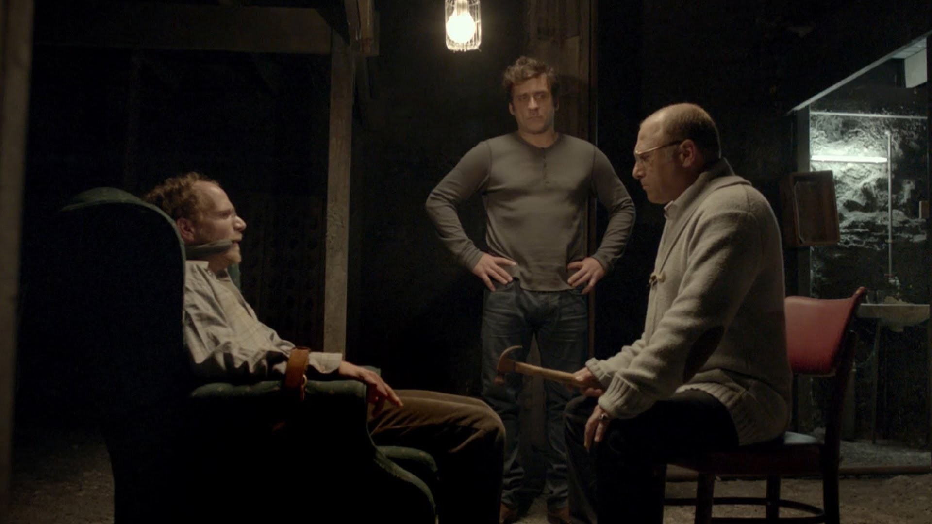 (l to r) Suspected killer Dror (Rotam Keinan) imprisoned by detective Mickey (Lior Ashkenazi) and victim's father Gidi (Tzahi Grad) in Big Bad Wolves (2013)