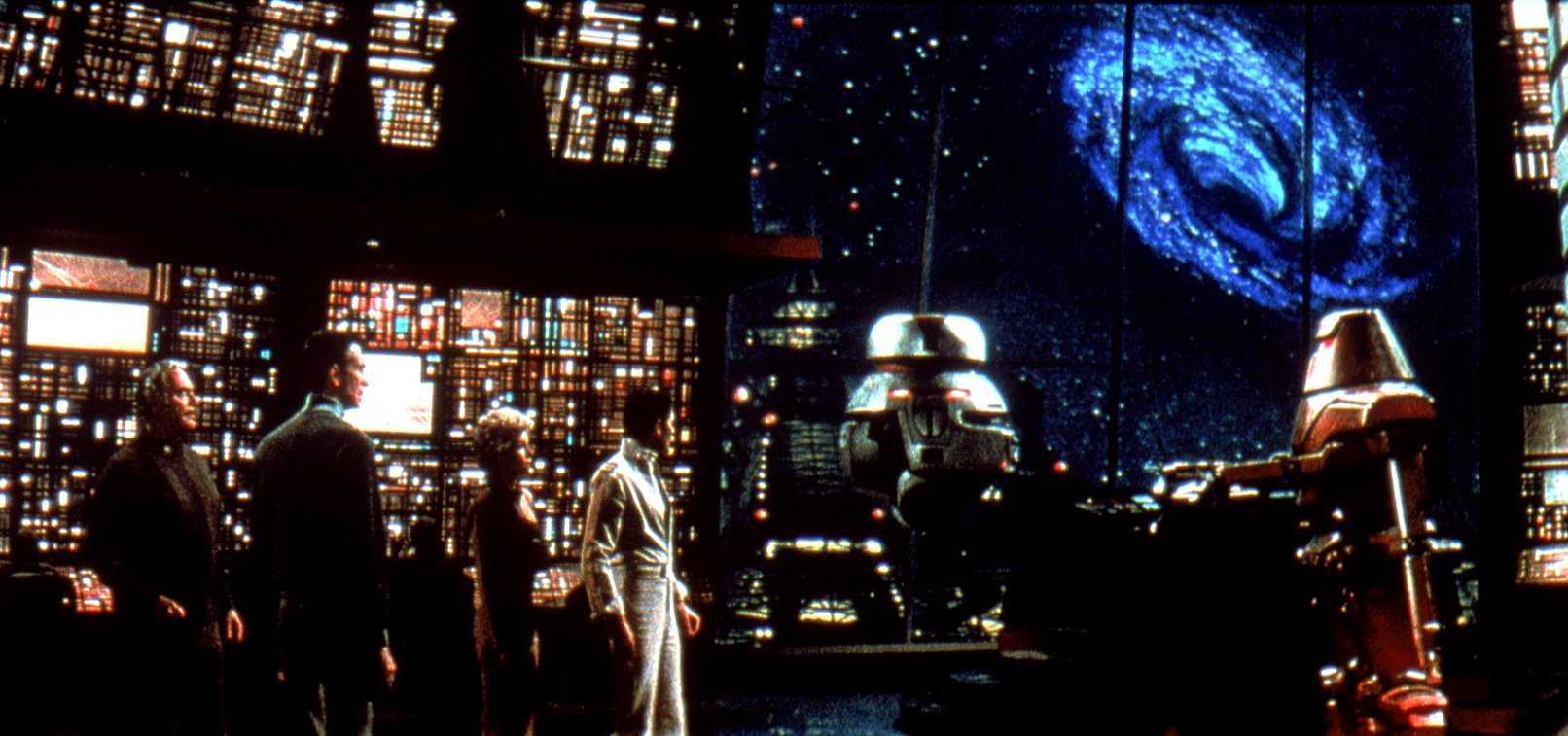 The Palomino crew - (l to r) Ernest Borgnine, Anthony Perkins, Yvette Mimieux and Joseph Bottoms along with the robots Vincent and Captain Star on the bridge of the Cygnus looking out at The Black Hole (1979)