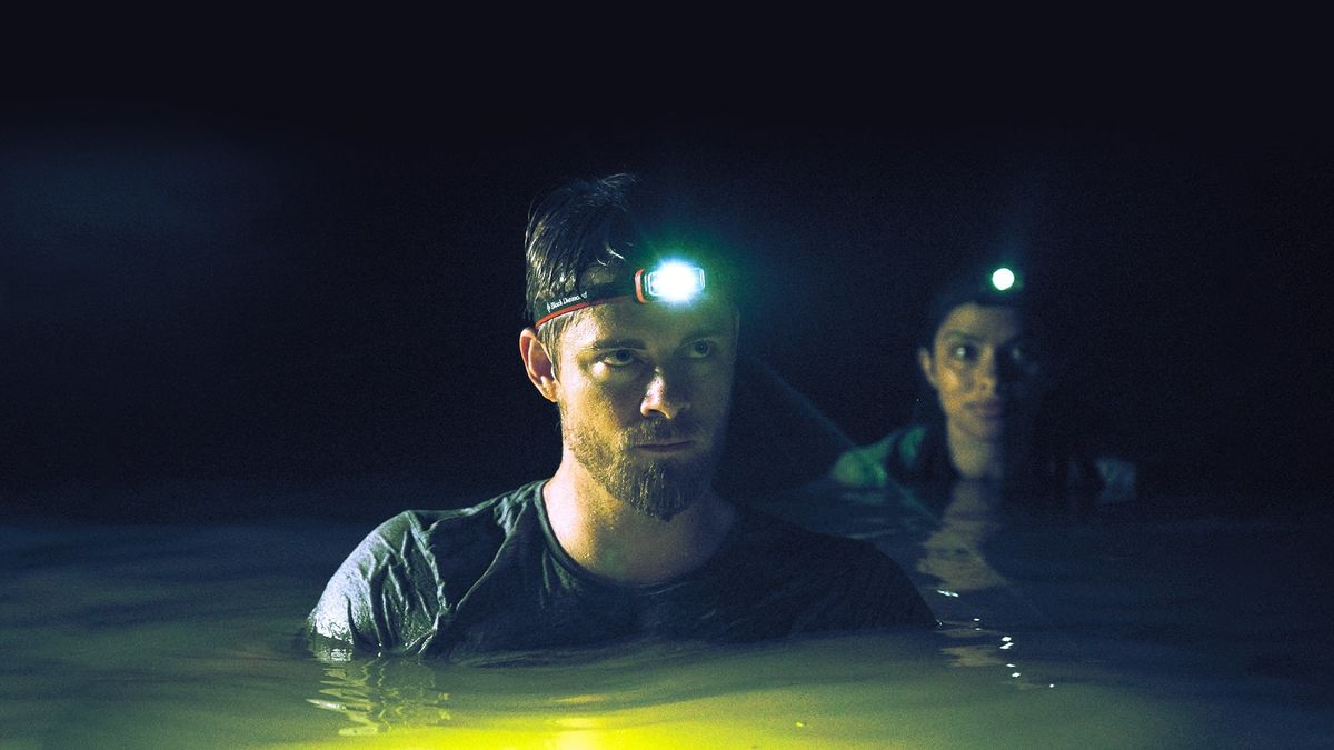 Luke Mitchell and Amali Golden venture through crocodile-infested waters in Black Water Abyss (2020)