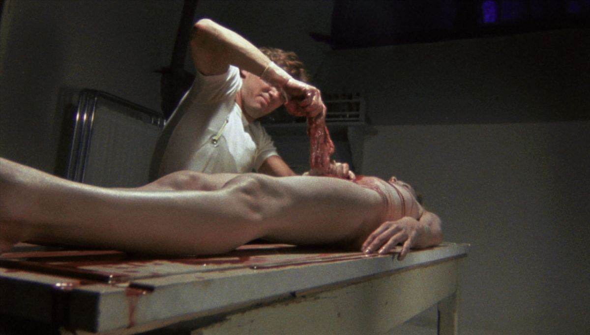 Kieran Canter removes the viscera from Cinzia Monreale's corpse in Blue Holocaust (1979)