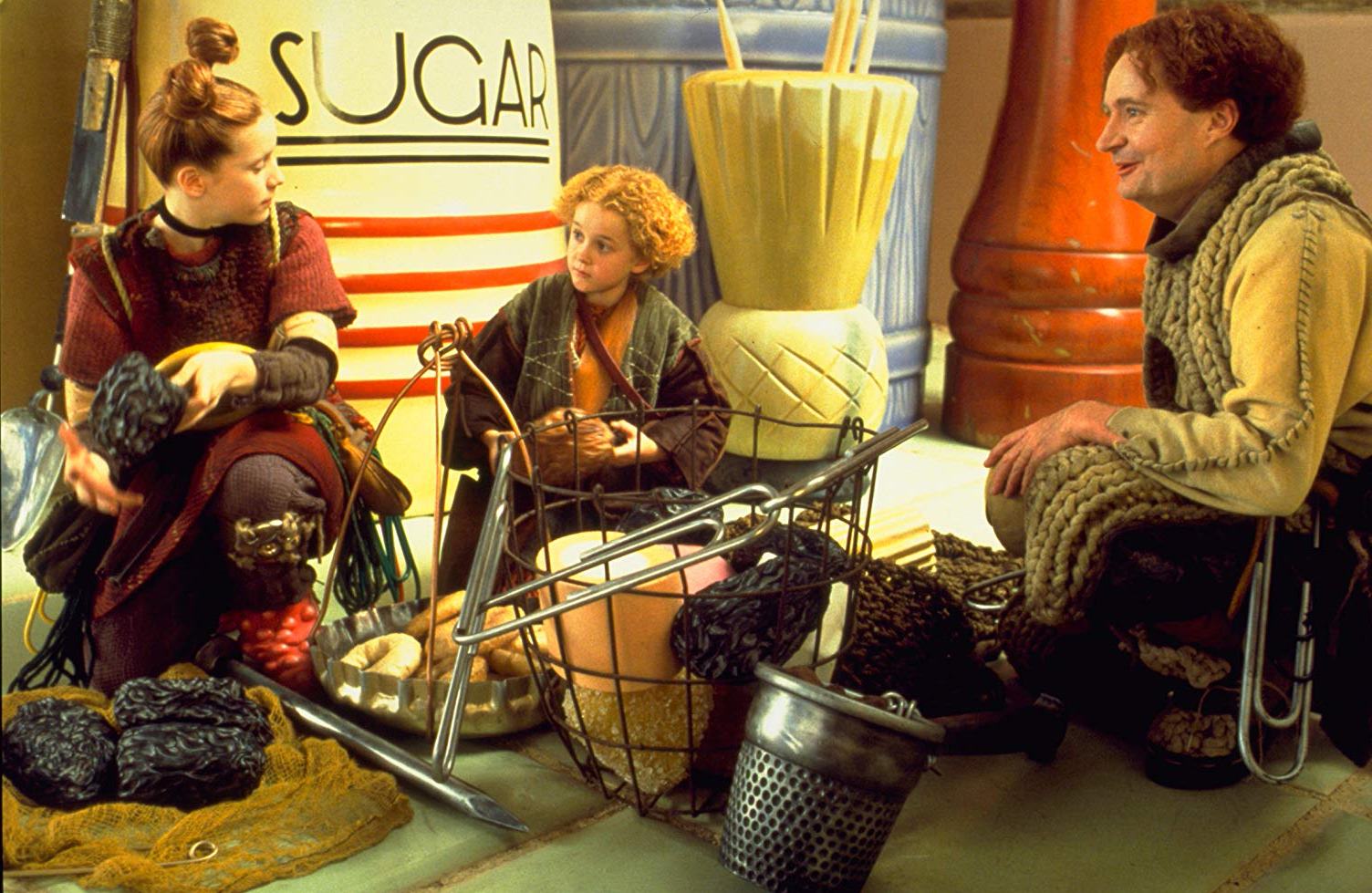 The Clock family prepare to go borrowing - (l to r) Arrietty (Flora Newbigin), Peagreen (Tom Felton) and father Pod (Jim Broadbent) in The Borrowers (1997)