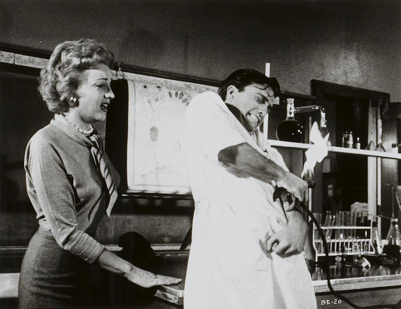 Joanna Lee looks on as Edwin Nelson tries to free himself of one of the parasites in The Brain Eaters (1958)