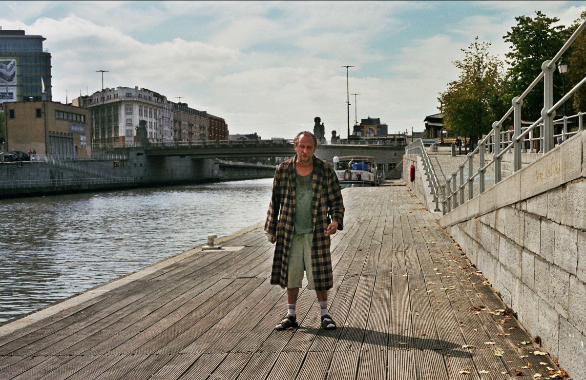 Benoit Poelvoorde as a scruffy, bad-tempered God, living in Brussels in The Brand New Testament (2015)