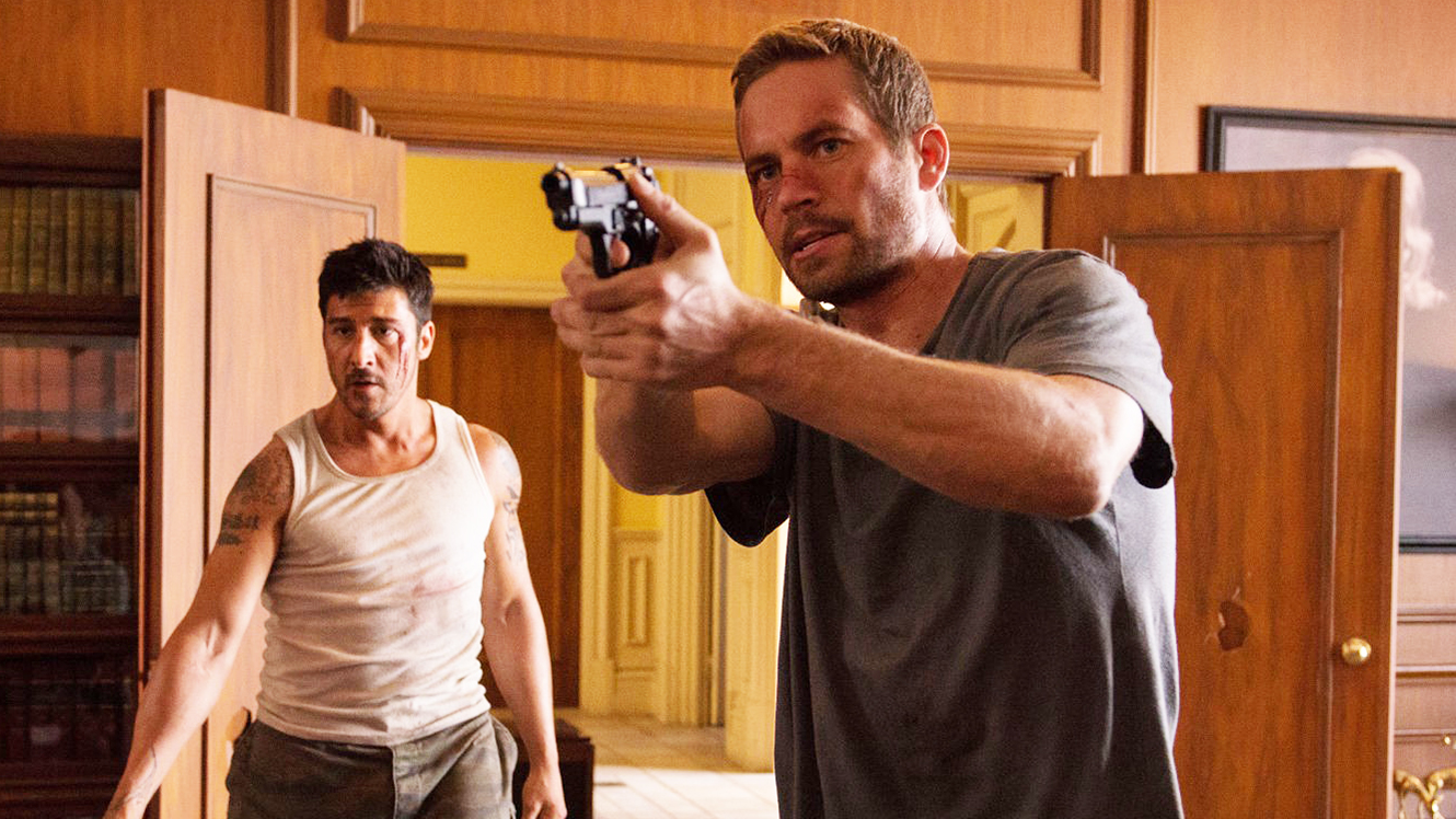 (l to r) Escaped prisoner David Belle and detective Paul Walker in Brick Mansions (2014)