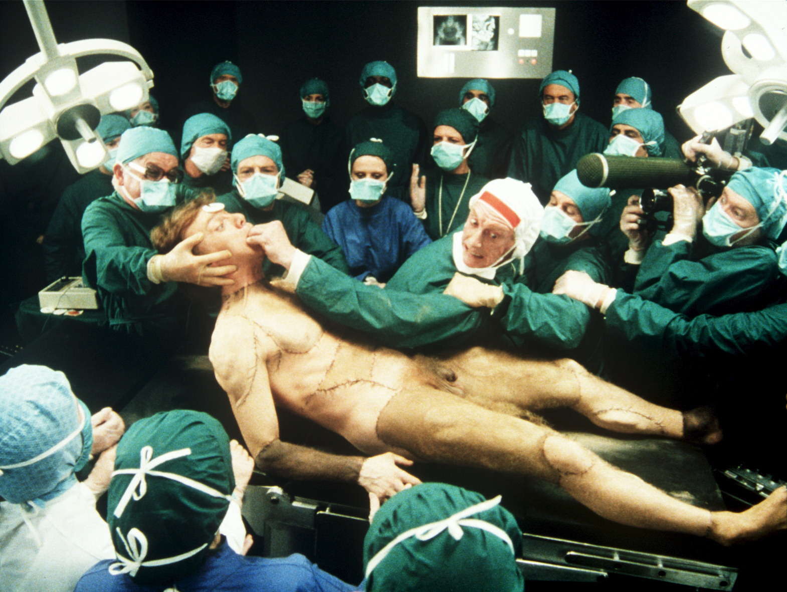 Professor Millar (Graham Crowden) unveils his Frankenstein creation (Malcolm McDowell) in Britannia Hospital (1982)