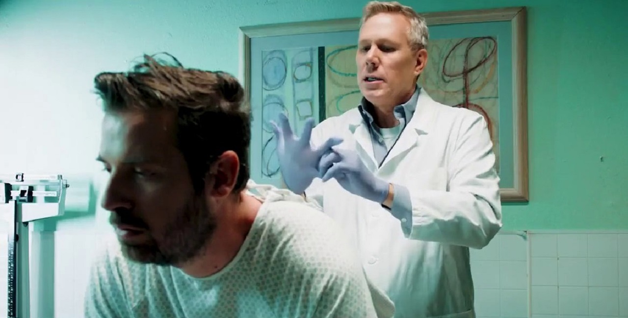 Chip Gutchell (Tyler Cornack) receives a rectal examination from his doctor in Butt Boy (2019)