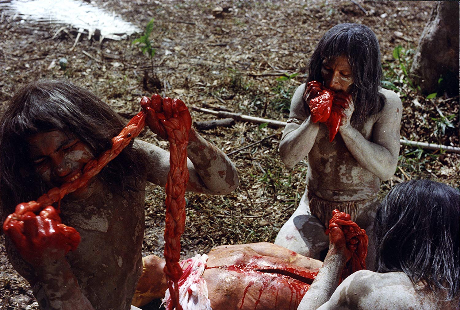 Natives munch on some intestines in Cannibal Ferox (1981)