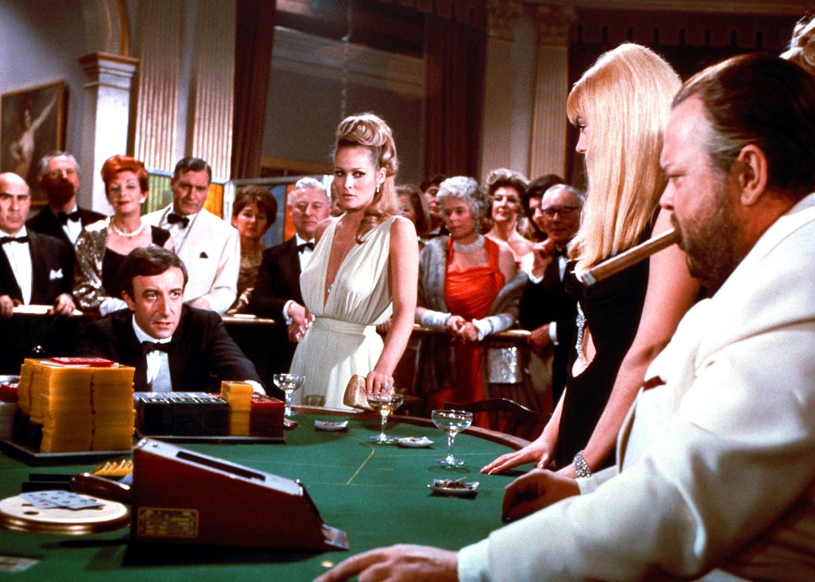 James Bond (Peter Sellers) faces down against Le Chiffre (Orson Welles) at the card table in the Casino Royale (1967)