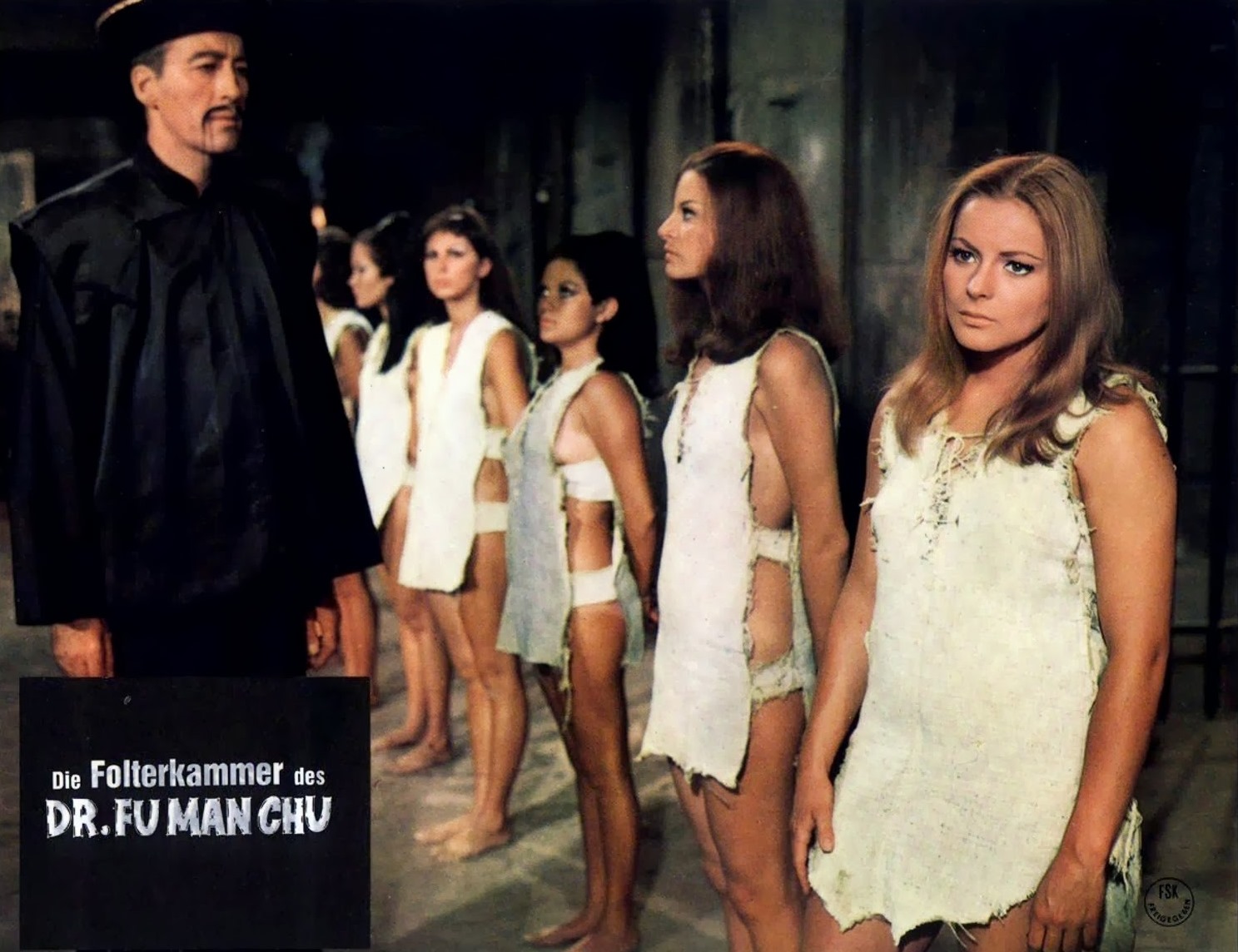 Fu Manchu (Christopher Lee) surveys his collection of women in The Castle of Fu Manchu (1969)