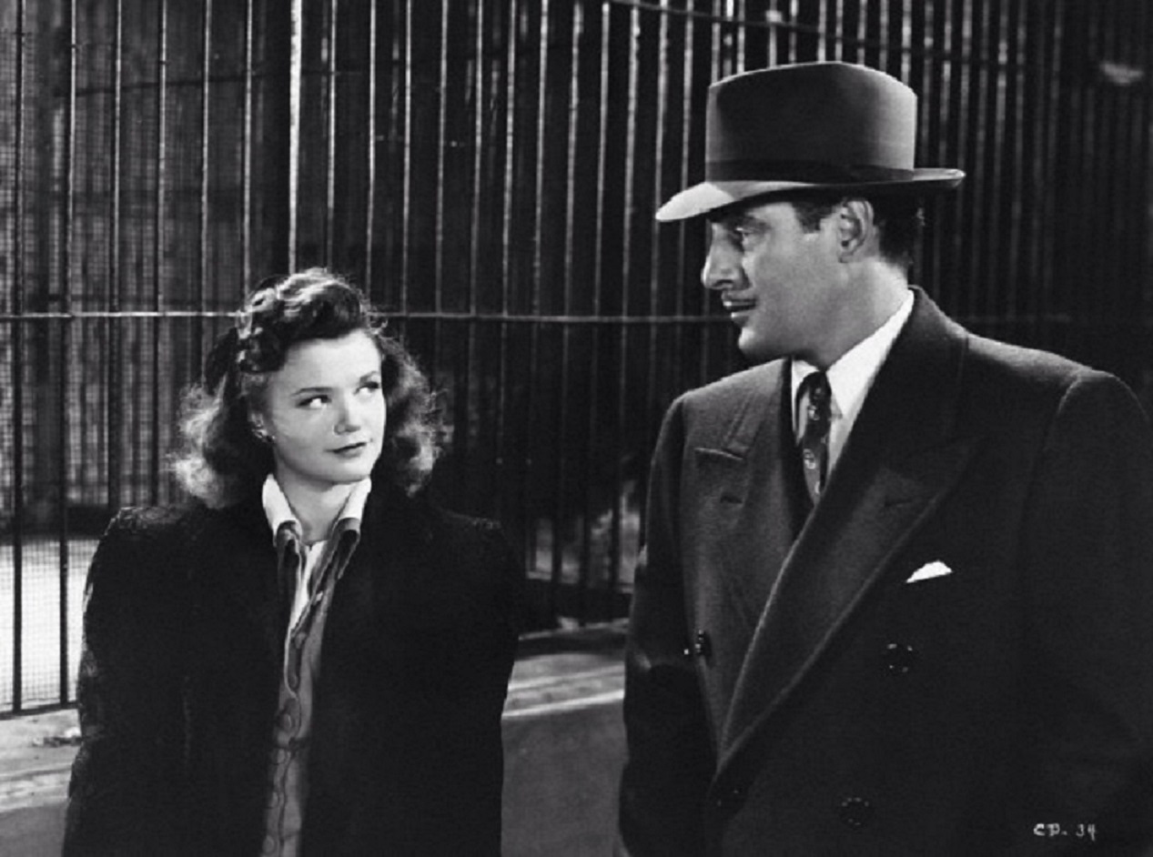 Kent Smith (Tom Conway) meets Irena Dubrovna (Simone Simon) at the Central Park Zoo in Cat People (1942)