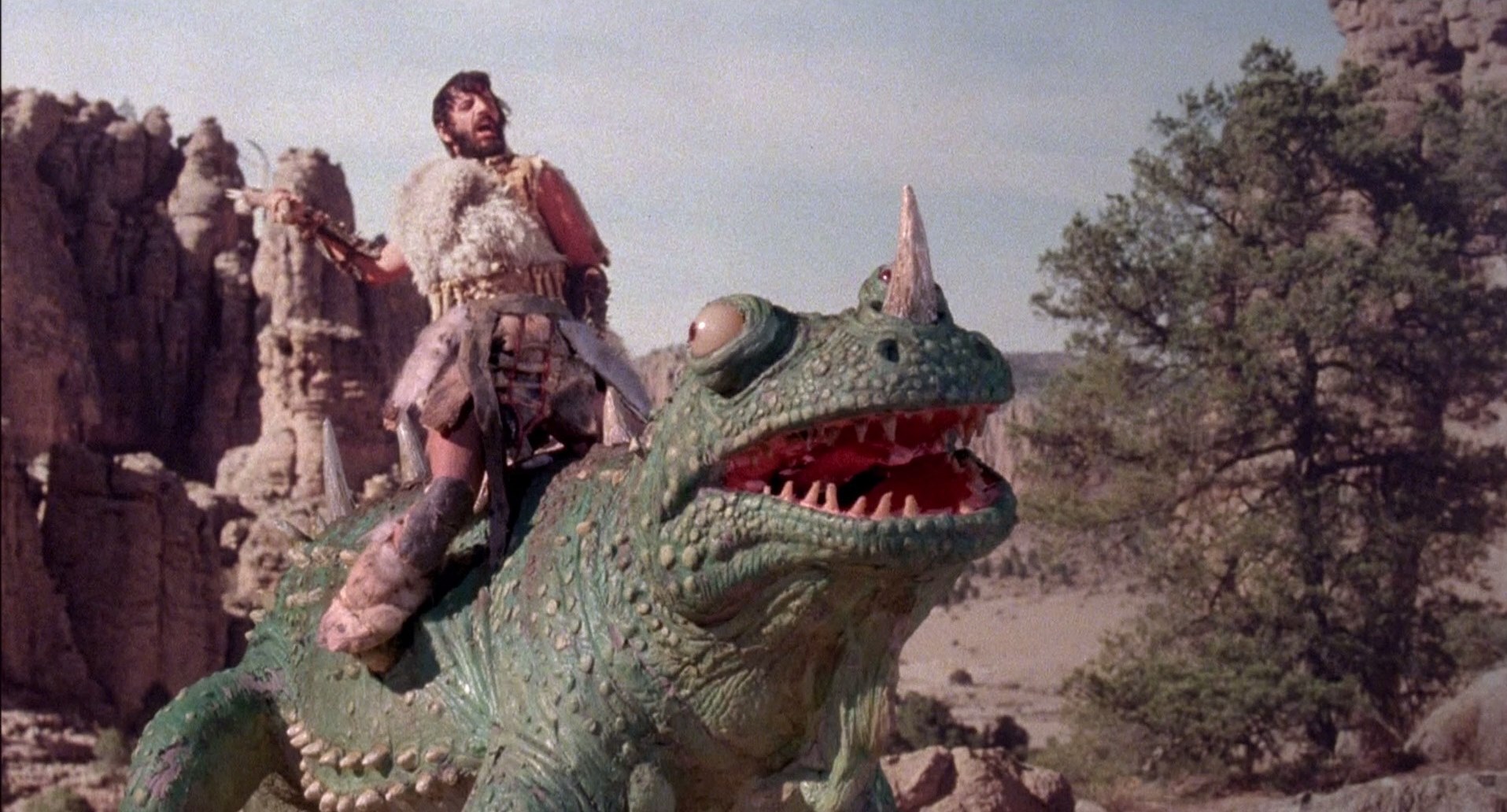 Ringo Starr on the back of a dinosaur in Caveman (1981)